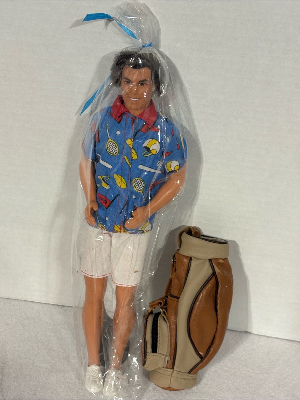 Barbie Ken Doll with Blue Tennis Print Shirt and Brown Golf Bag